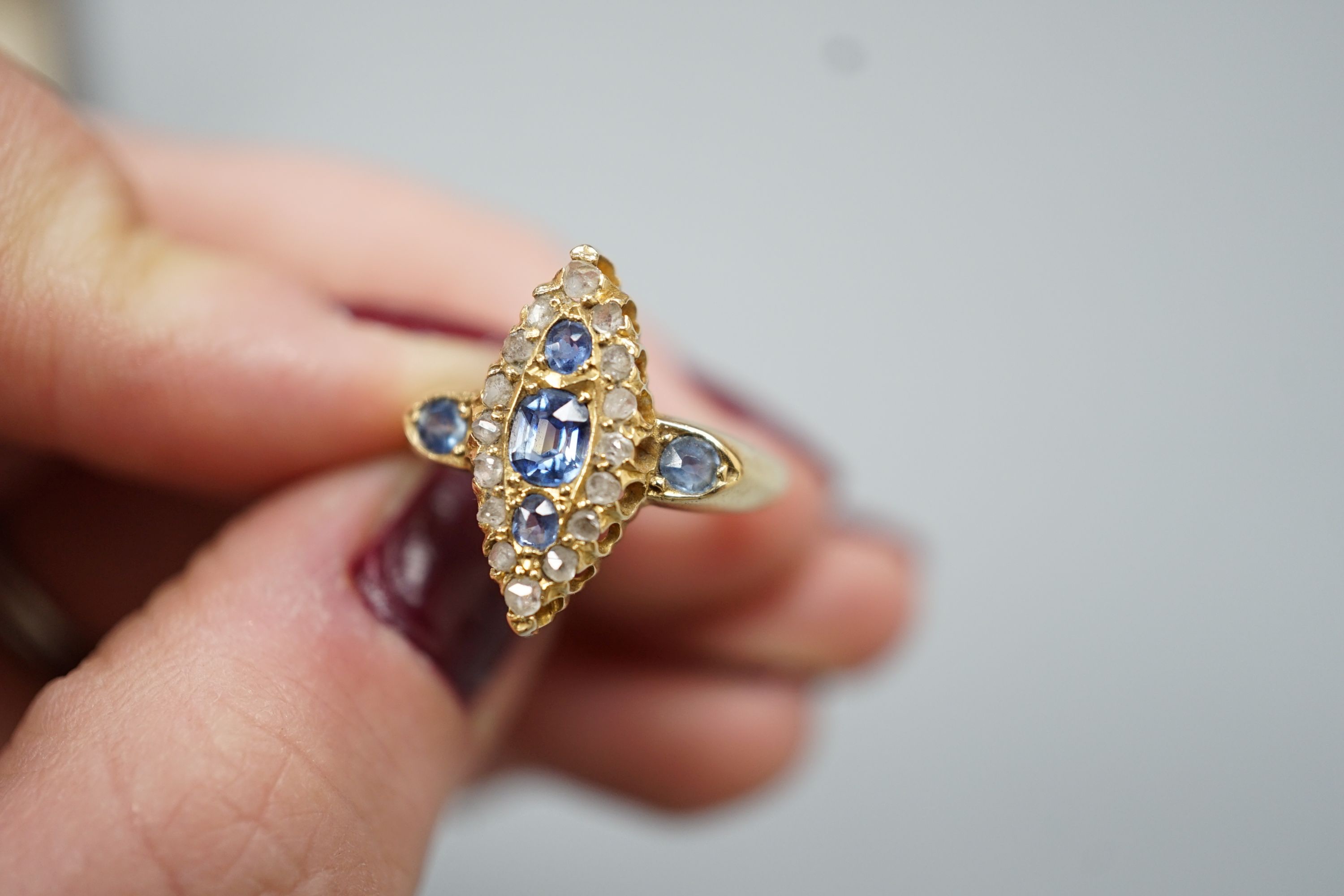 An Edwardian 18ct gold, sapphire and diamond set marquise set cluster ring, size K, gross weight 3.2 grams